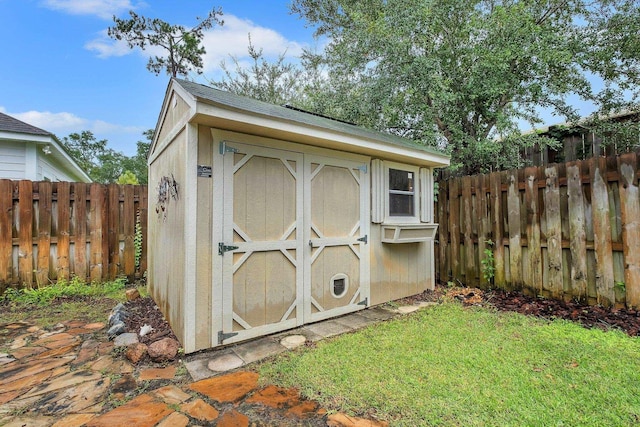 view of outbuilding featuring a lawn