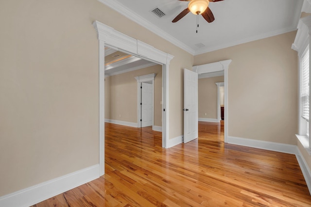 unfurnished room with ceiling fan, light hardwood / wood-style floors, and crown molding