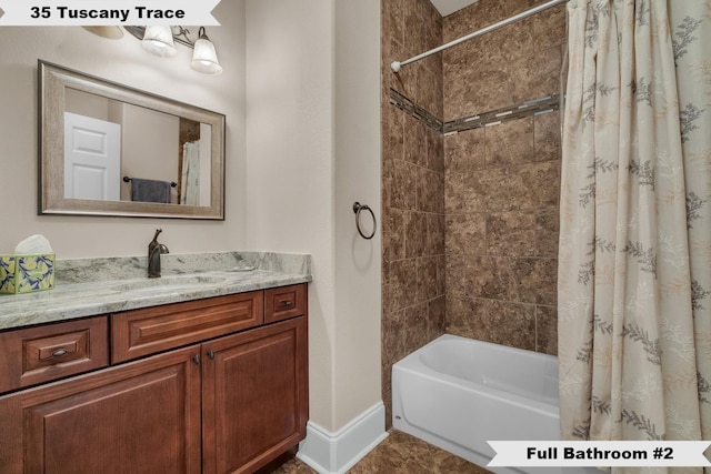 bathroom featuring vanity and shower / tub combo with curtain