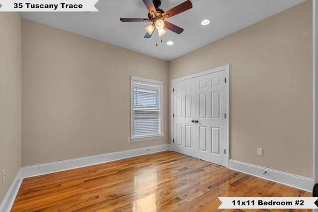 unfurnished bedroom featuring ceiling fan, a closet, and light hardwood / wood-style floors