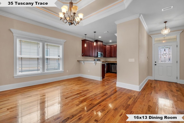 kitchen featuring ornamental molding, decorative light fixtures, and an inviting chandelier