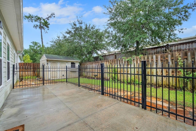 view of patio / terrace with a garage and an outbuilding