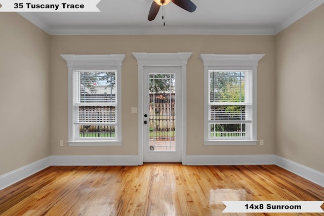 entryway with ceiling fan, wood-type flooring, and ornamental molding