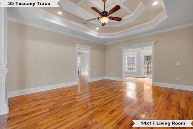 unfurnished room featuring a raised ceiling, crown molding, light hardwood / wood-style flooring, and ceiling fan