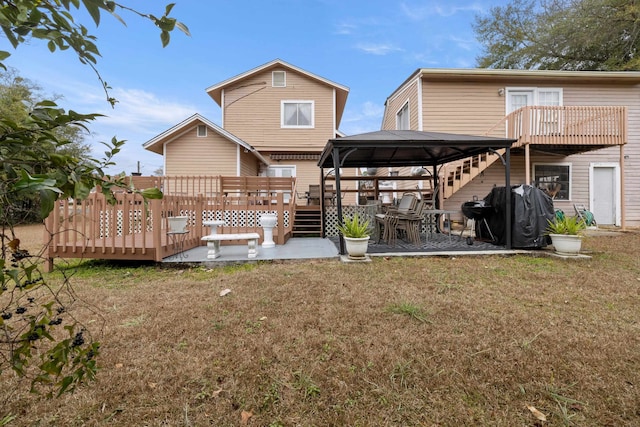 back of house with a gazebo, a yard, and a wooden deck