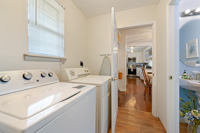 washroom featuring washer and dryer and light hardwood / wood-style floors