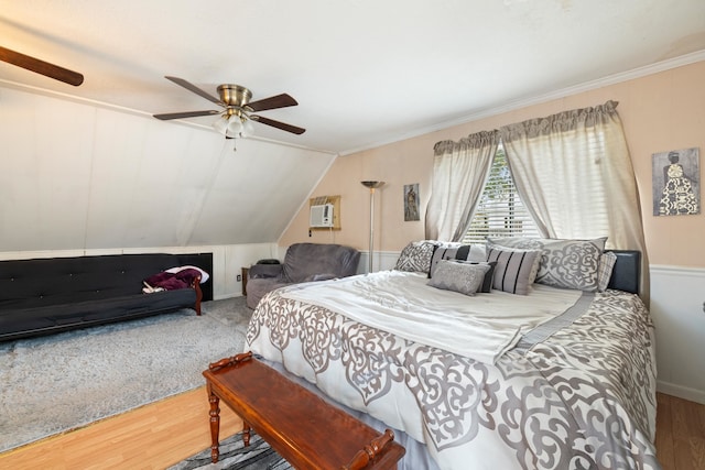 bedroom with vaulted ceiling, hardwood / wood-style floors, ceiling fan, and crown molding