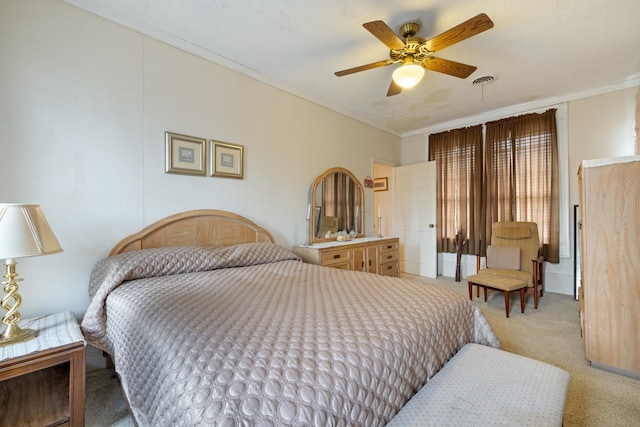 carpeted bedroom featuring ornamental molding and ceiling fan