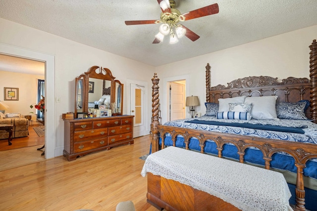 bedroom featuring ceiling fan, a textured ceiling, and light wood-type flooring