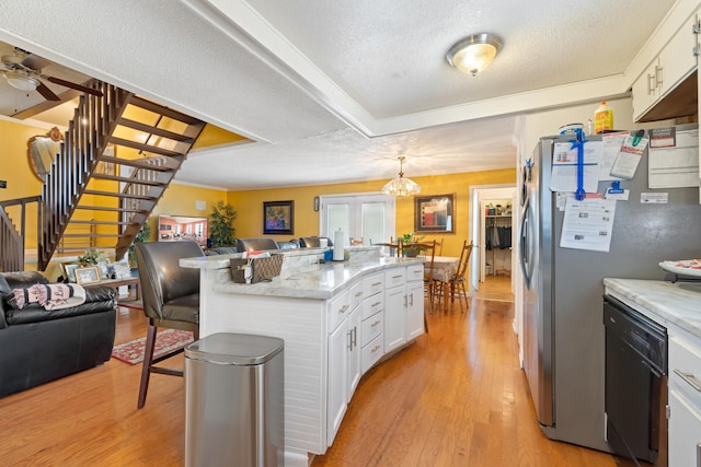 kitchen featuring decorative light fixtures, stainless steel refrigerator, dishwasher, light hardwood / wood-style floors, and white cabinets