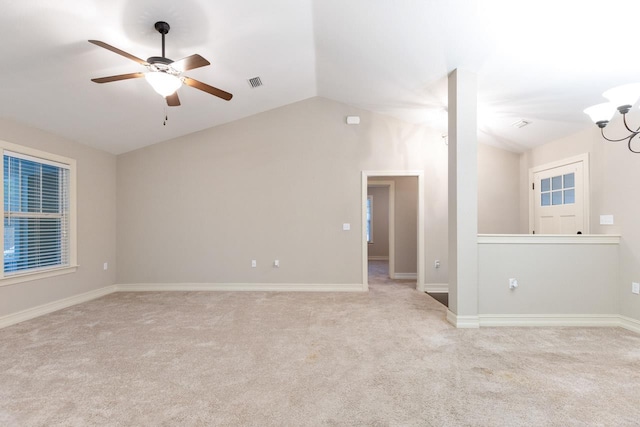 unfurnished room featuring lofted ceiling, visible vents, light carpet, and ceiling fan with notable chandelier