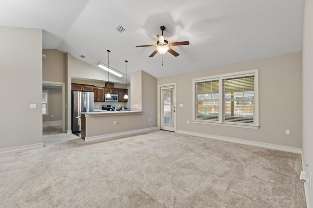 unfurnished living room with light colored carpet, visible vents, plenty of natural light, and ceiling fan