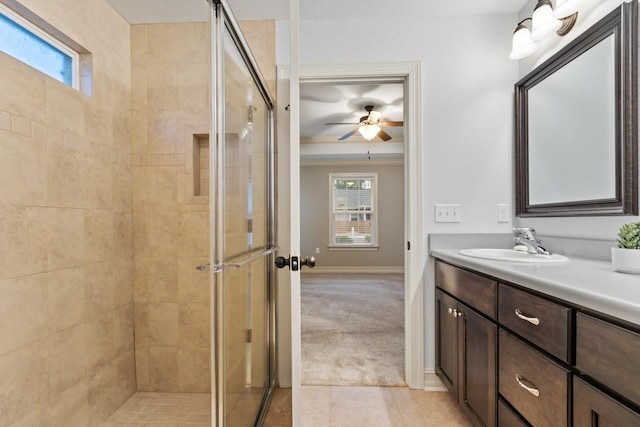 full bathroom featuring baseboards, a ceiling fan, tile patterned floors, vanity, and a shower stall