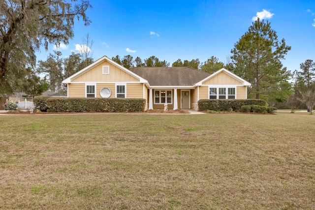 ranch-style house featuring board and batten siding and a front yard