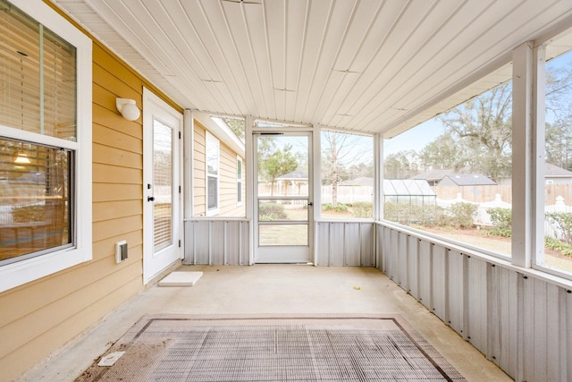 unfurnished sunroom with wooden ceiling and a wealth of natural light