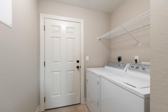 washroom featuring laundry area, light tile patterned floors, and independent washer and dryer