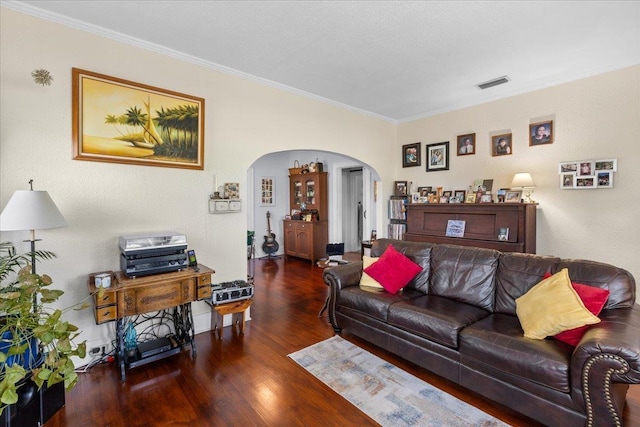 514 N Calhoun St, Perry, FL 32347 - living room featuring arched walkways, crown molding, and wood finished floors