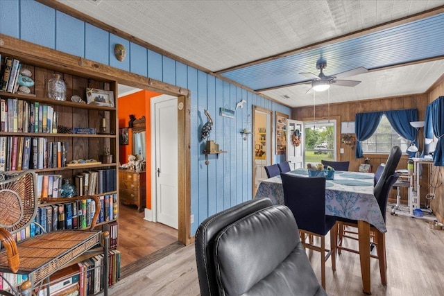 514 N Calhoun St, Perry, FL 32347 - dining room with wooden walls, ceiling fan, and light wood-style floors