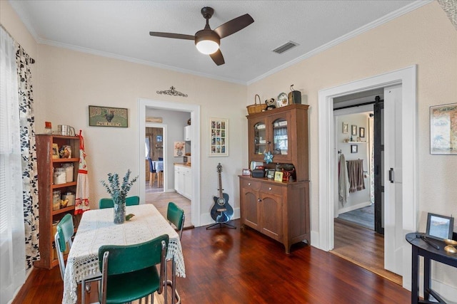 514 N Calhoun St, Perry, FL 32347 - dining room featuring a ceiling fan, crown molding, and dark wood-type flooring