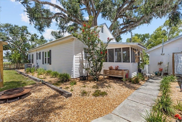 514 N Calhoun St, Perry, FL 32347 - view of side of home featuring a sunroom and a central AC unit