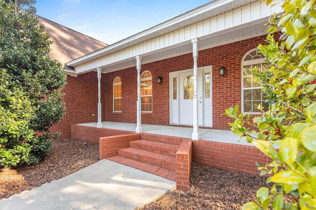 view of exterior entry featuring a porch