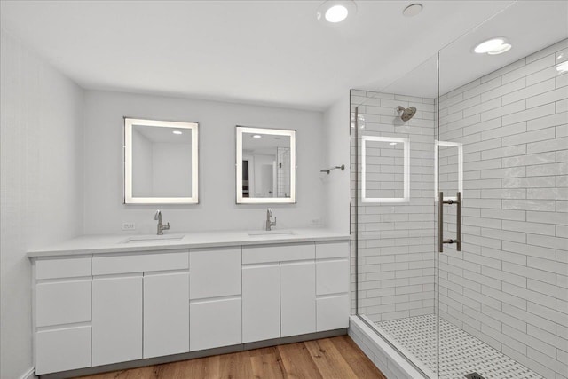 300 S Duval St Unit 2209, Tallahassee, FL 32301 - bathroom with a shower stall, double vanity, wood finished floors, and recessed lighting