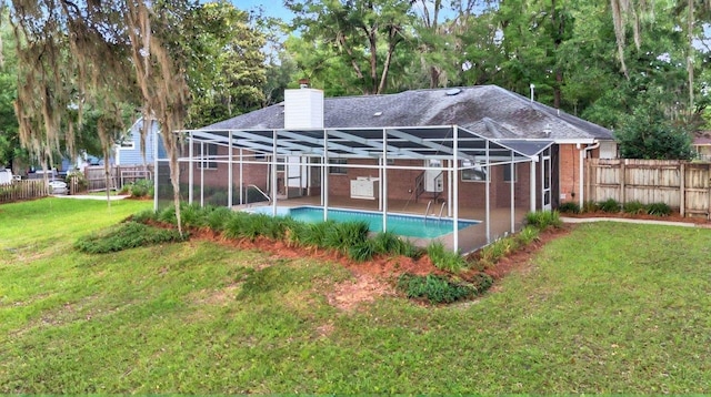 4640 Inisheer Dr, Tallahassee, FL 32309 - back of property featuring a chimney, a lanai, roof with shingles, a patio area, and brick siding