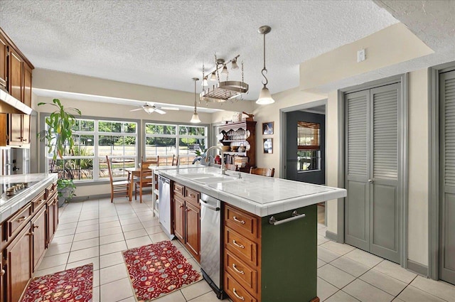 7390 Skipper Ln, Tallahassee, FL 32317 - kitchen with a textured ceiling, light tile patterned floors, an island with sink, and a sink