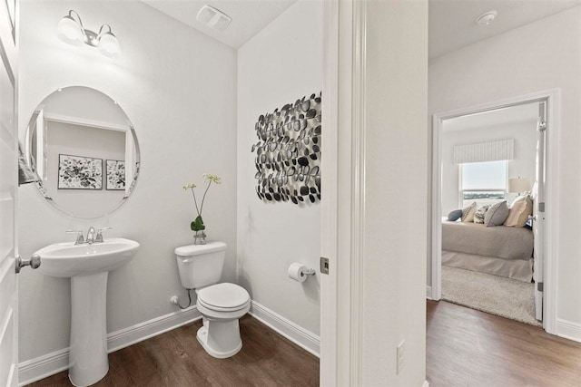 bathroom featuring hardwood / wood-style floors, toilet, and sink