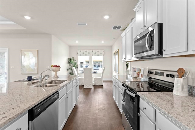 kitchen featuring white cabinets, stainless steel appliances, sink, and dark hardwood / wood-style flooring