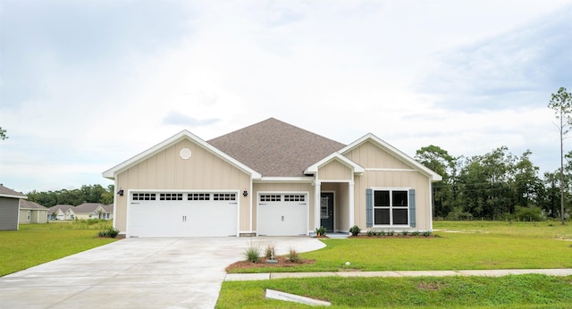 view of front of property with a garage and a front lawn