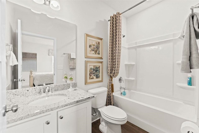 full bathroom featuring toilet, vanity, shower / bath combo with shower curtain, and hardwood / wood-style flooring