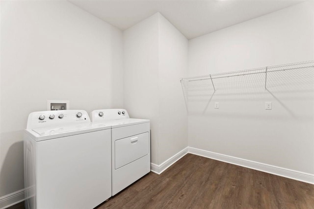 laundry area with dark hardwood / wood-style floors and independent washer and dryer