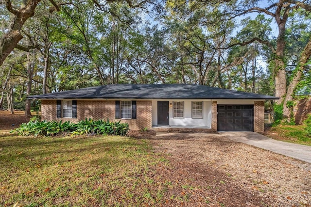 ranch-style house featuring a garage and a front yard