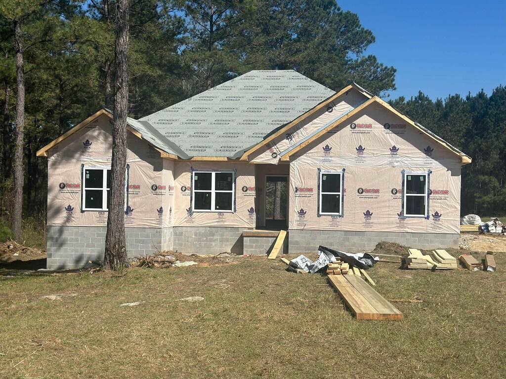 property in mid-construction featuring crawl space and a front lawn