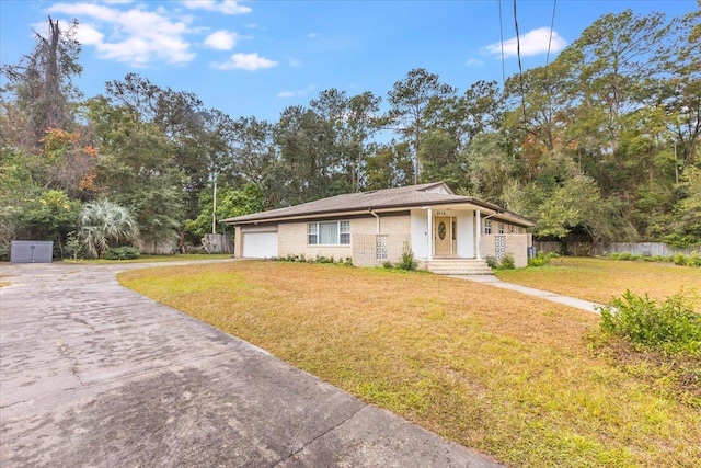 single story home with a garage and a front lawn