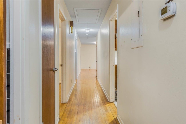 hallway with light hardwood / wood-style floors