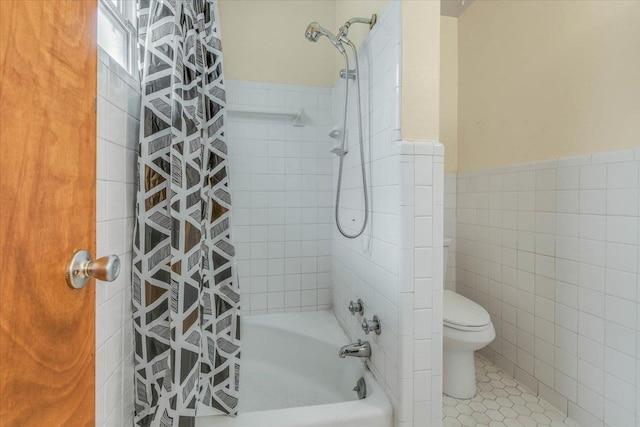 bathroom featuring tile patterned flooring, toilet, tile walls, and shower / tub combo with curtain