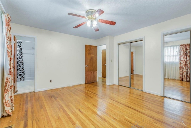 unfurnished bedroom with ceiling fan, light wood-type flooring, and a textured ceiling