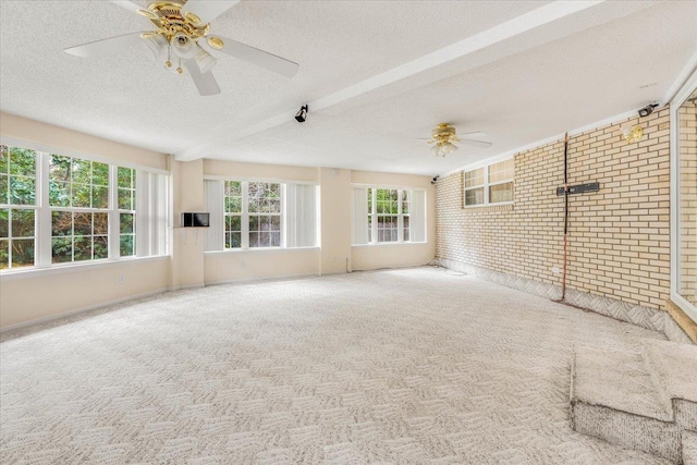 unfurnished sunroom featuring ceiling fan