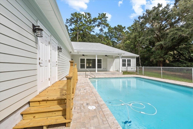 view of swimming pool with ceiling fan and a patio area