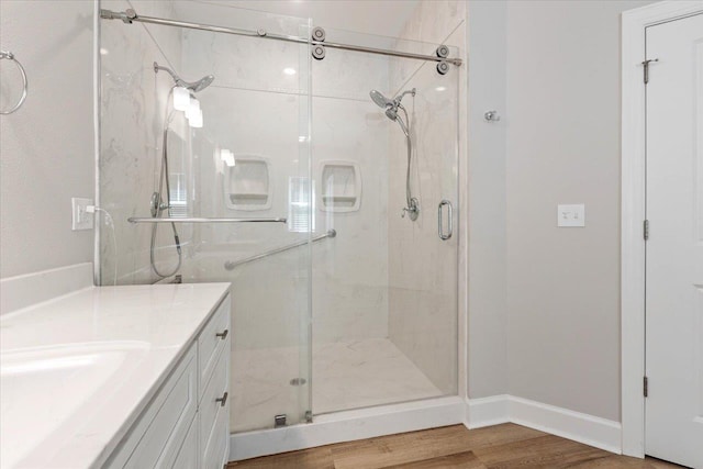 bathroom with vanity, hardwood / wood-style flooring, and an enclosed shower