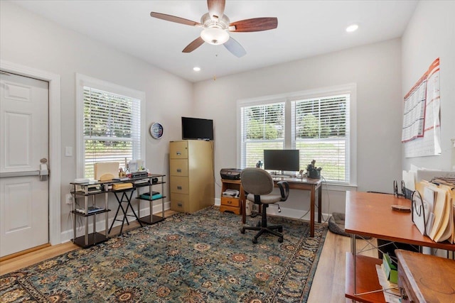 office with hardwood / wood-style floors, ceiling fan, and a healthy amount of sunlight