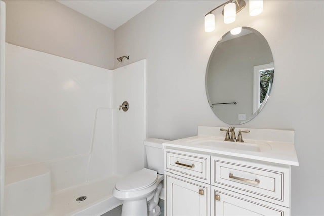 bathroom with a shower, vanity, and toilet