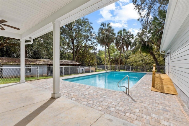 view of swimming pool featuring ceiling fan and a patio area