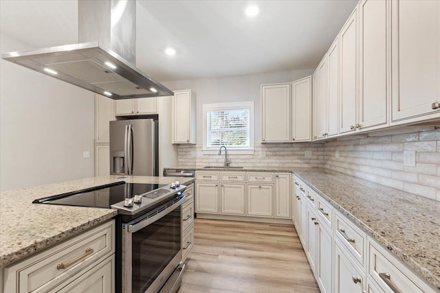 kitchen with light stone countertops, sink, stainless steel appliances, island exhaust hood, and white cabinets