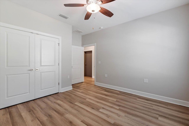 unfurnished bedroom with ceiling fan, light hardwood / wood-style flooring, and a closet