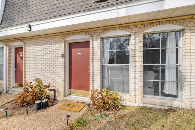 2020 Continental Ave Unit 144, Tallahassee, FL 32304 - doorway to property featuring a shingled roof and brick siding