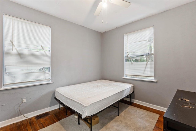 bedroom featuring ceiling fan and dark hardwood / wood-style floors