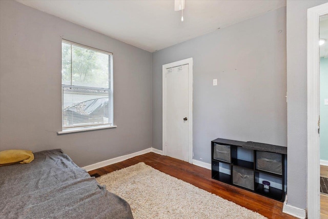 bedroom with dark hardwood / wood-style flooring